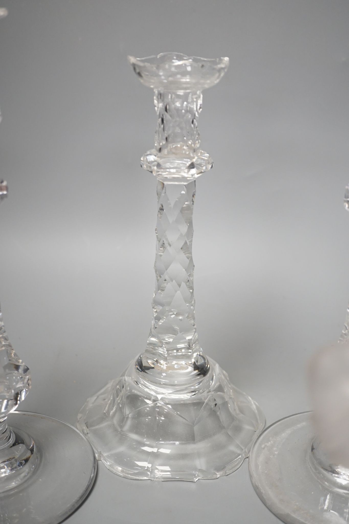 Five various cut glass candlesticks, a pair of John Ford, Holyrood Glass Works, Edinburgh figural frosted glass candlesticks and a lustre drop bag chandelier